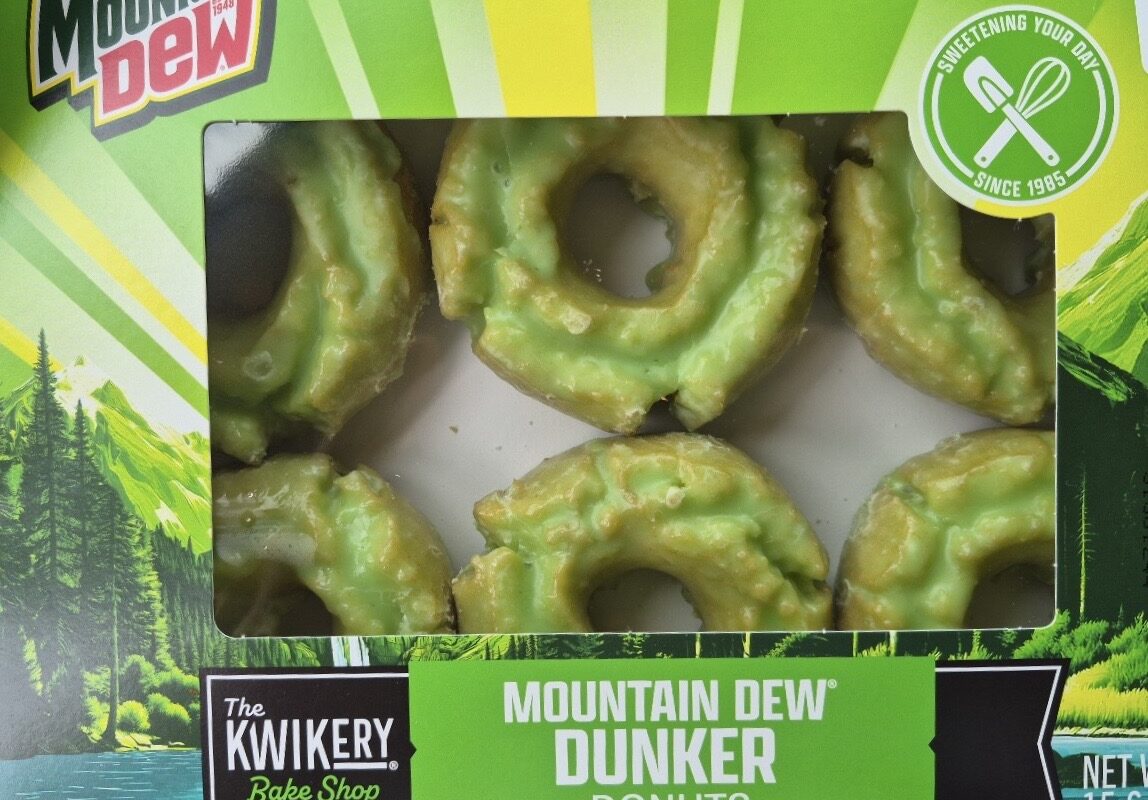 Box of Mountain Dew Dunker Donuts from The Kwikery Bake Shop, six green glazed ring donuts visible through the clear window.