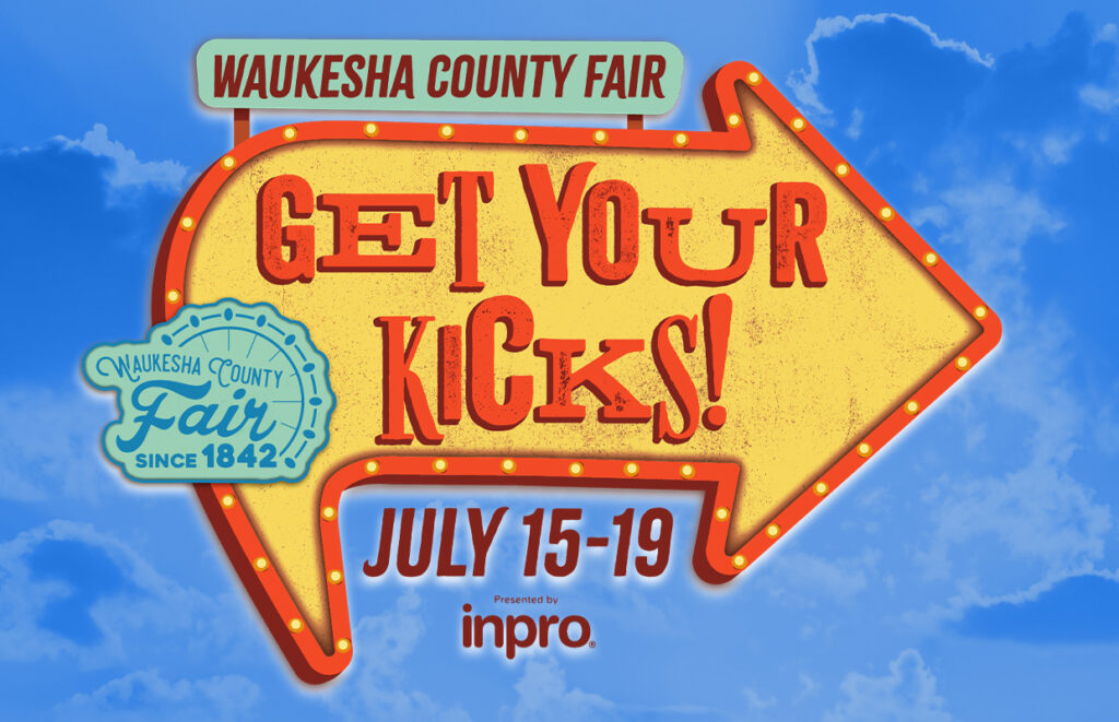 Bright yellow arrow sign reading 'Get Your Kicks!' for Waukesha County Fair, July 15–19, against a blue sky background.