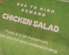 Sign on green grass announcing chicken salad: due to high demand, there is a 2-pound maximum; thank you for your understanding.